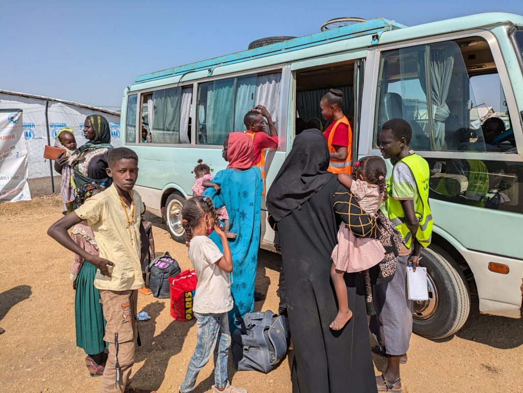 Refugees waiting to be transported to an aid camp