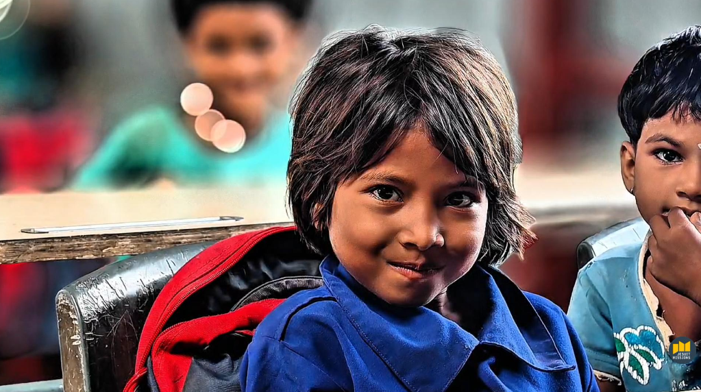 Boy in class looking towards camera