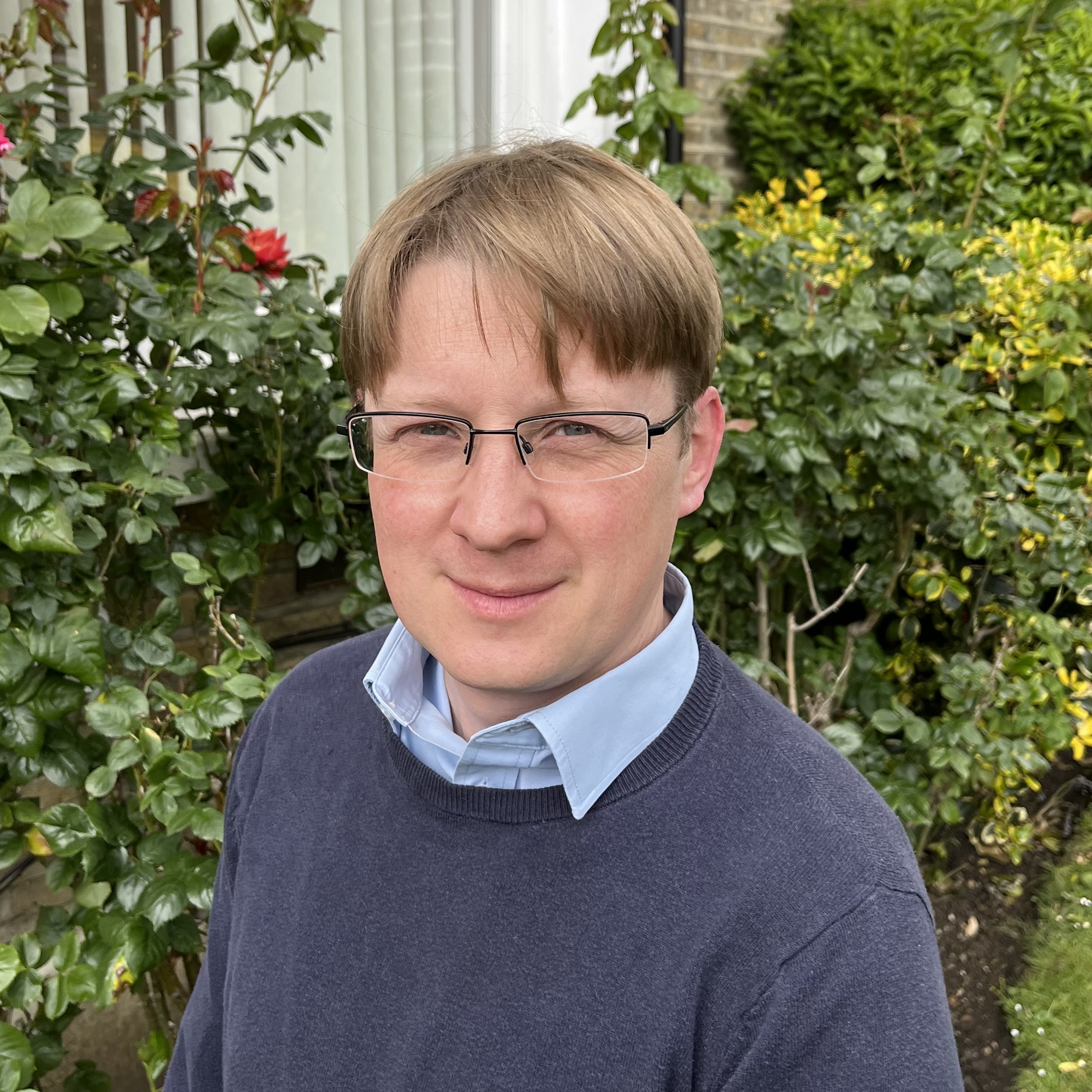 Man standing in the garden looking towards the camera