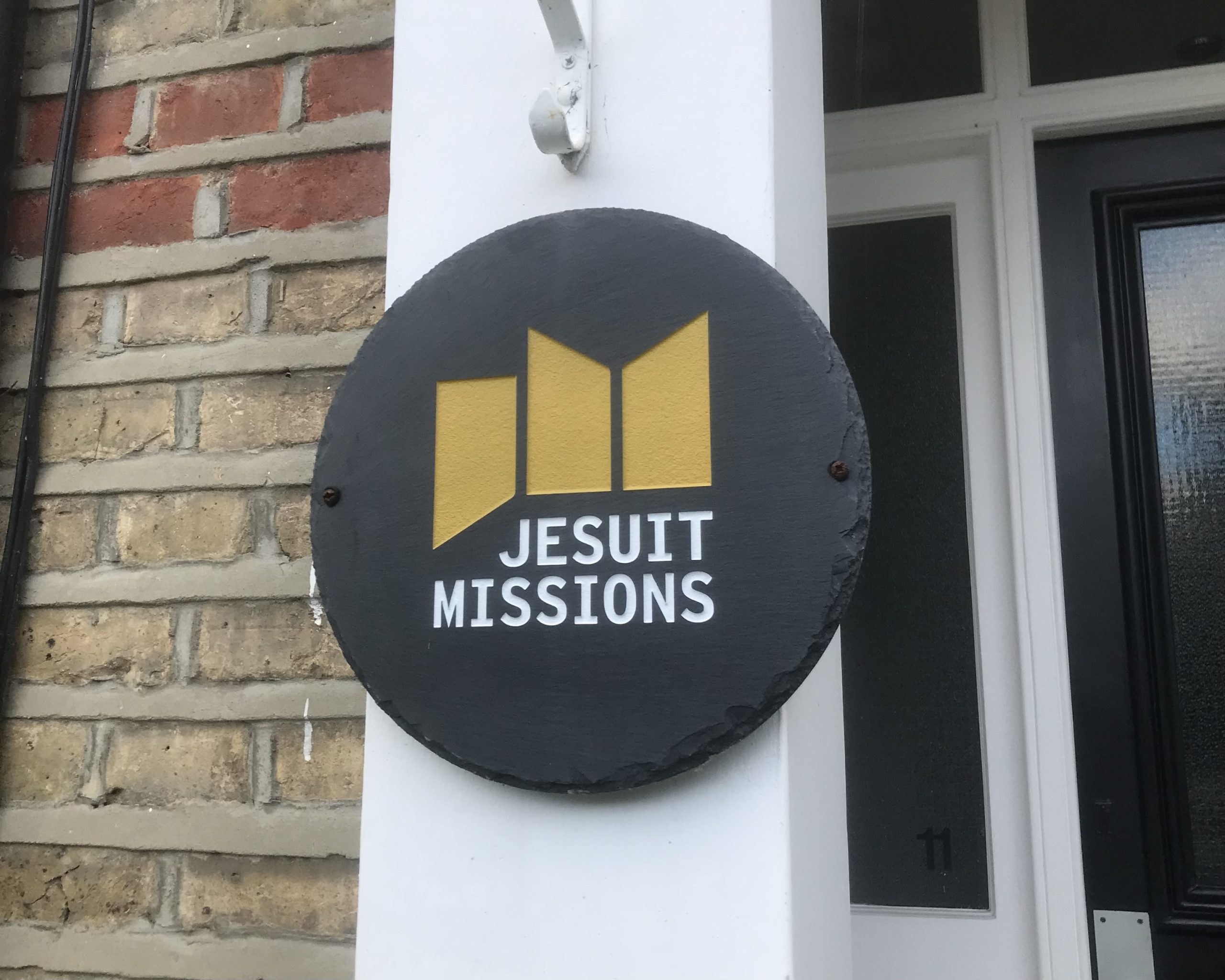 The Jesuit Missions logo attached to the front of an office