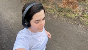 A woman wearing headphones out on a run