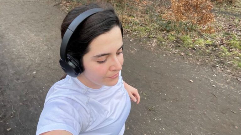 A woman wearing headphones out on a run