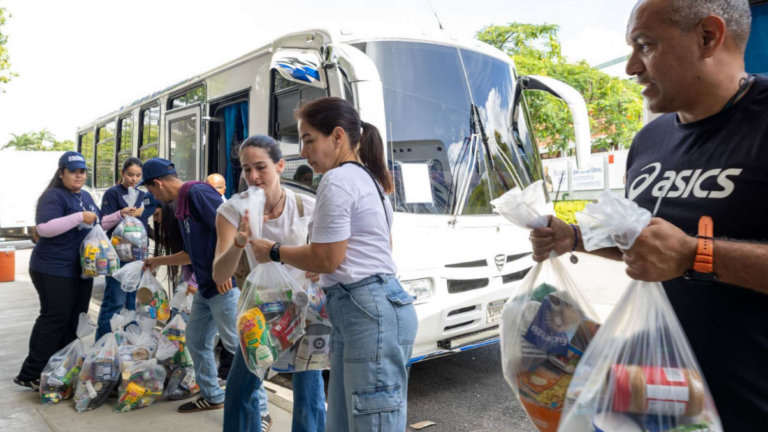 People passing bags of goods to each other in a line